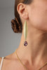 long gold-plated earrings with pink crystal on model
