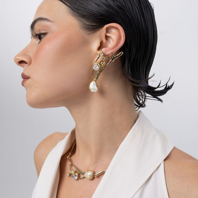 Brass pearl drop earring worn with matching necklace, side profile