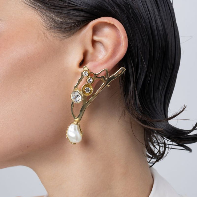 Handmade brass branch earring with pearl drop worn on ear,