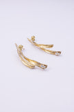 Pixie Earrings flat lay, handmade brass linear earrings with elongated split silhouette and crystal accent