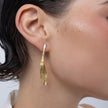 Pixie Earrings on model, handmade brass long earrings worn on ear showing length and graceful movement