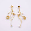 Brass long drop earrings pair with clear crystal flowers and pearl buds, product shot