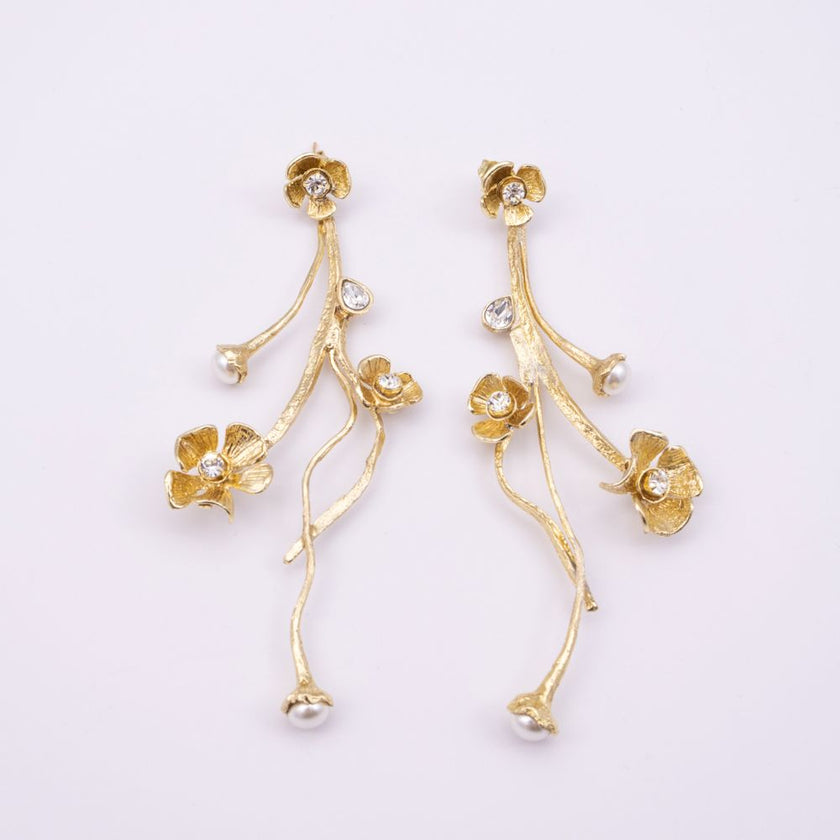 Brass long drop earrings pair with clear crystal flowers and pearl buds, product shot