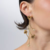 Handmade brass layered floral drop earring with amethyst crystal, worn on ear