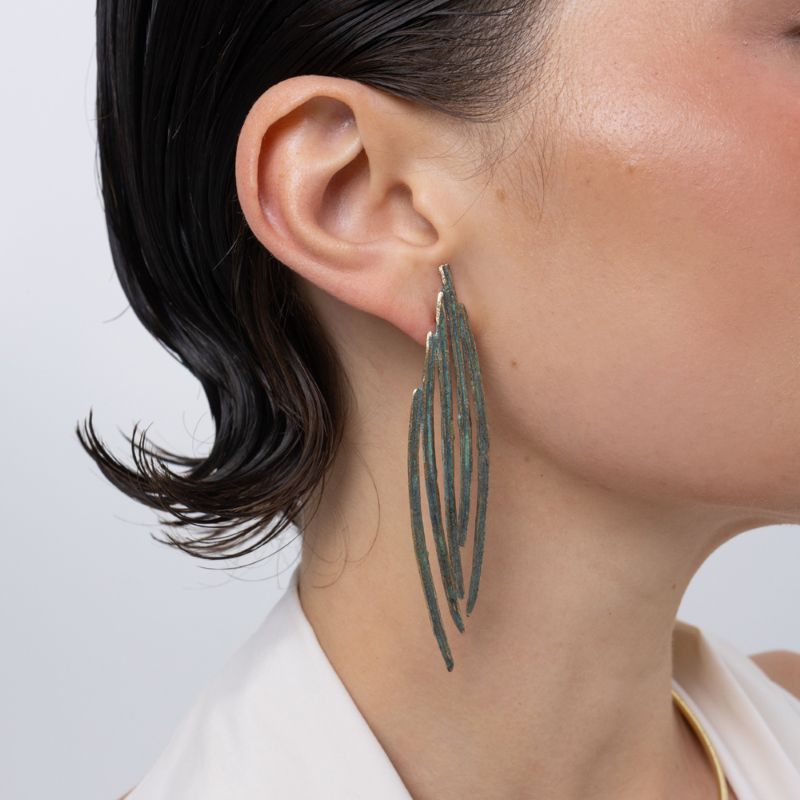 Pine Earrings on model, handmade brass long feather earrings worn on ear showing length and movement