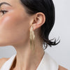 Pine Earrings, handmade brass long drop earrings with layered peacock feather blades and etched texture on model