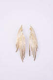 Double Pine Earrings, handmade brass long drop earrings with layered peacock feather blades and etched texture on white background