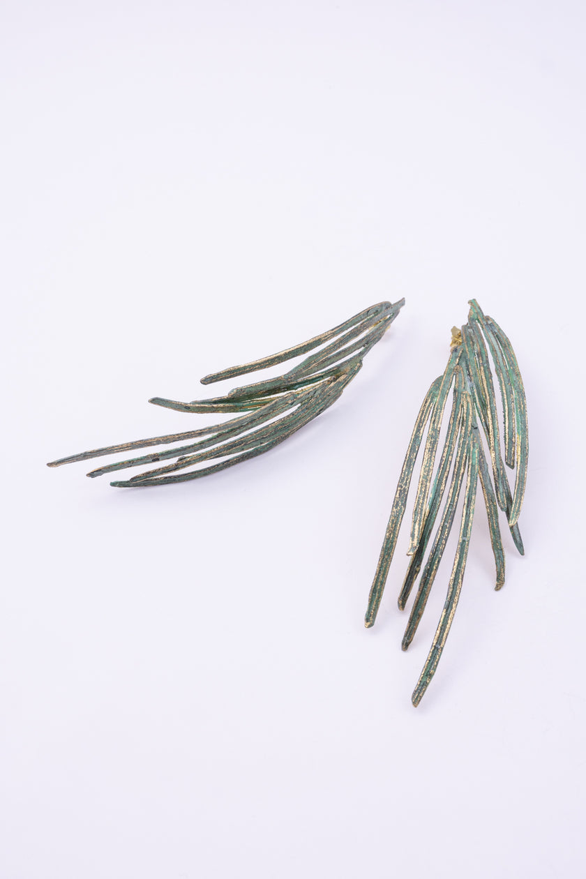 Double Pine Earrings close-up, handmade brass earrings with fine grooved feather texture and bright varnished finish