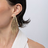 Double Pine Earrings on model, handmade brass long feather earrings worn on ear showing length and movement