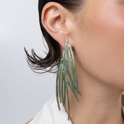 Double Pine Earrings detail, handmade brass earrings with overlapping slender blades and post fastening