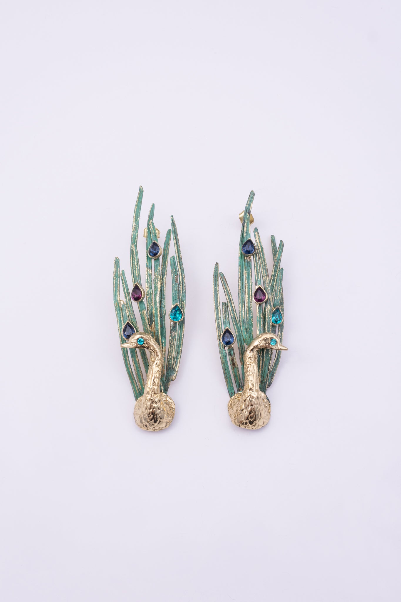 Peacock Earrings, handmade brass long drop earrings with sculpted peacock, patinated feather blades and teardrop crystals on white background
