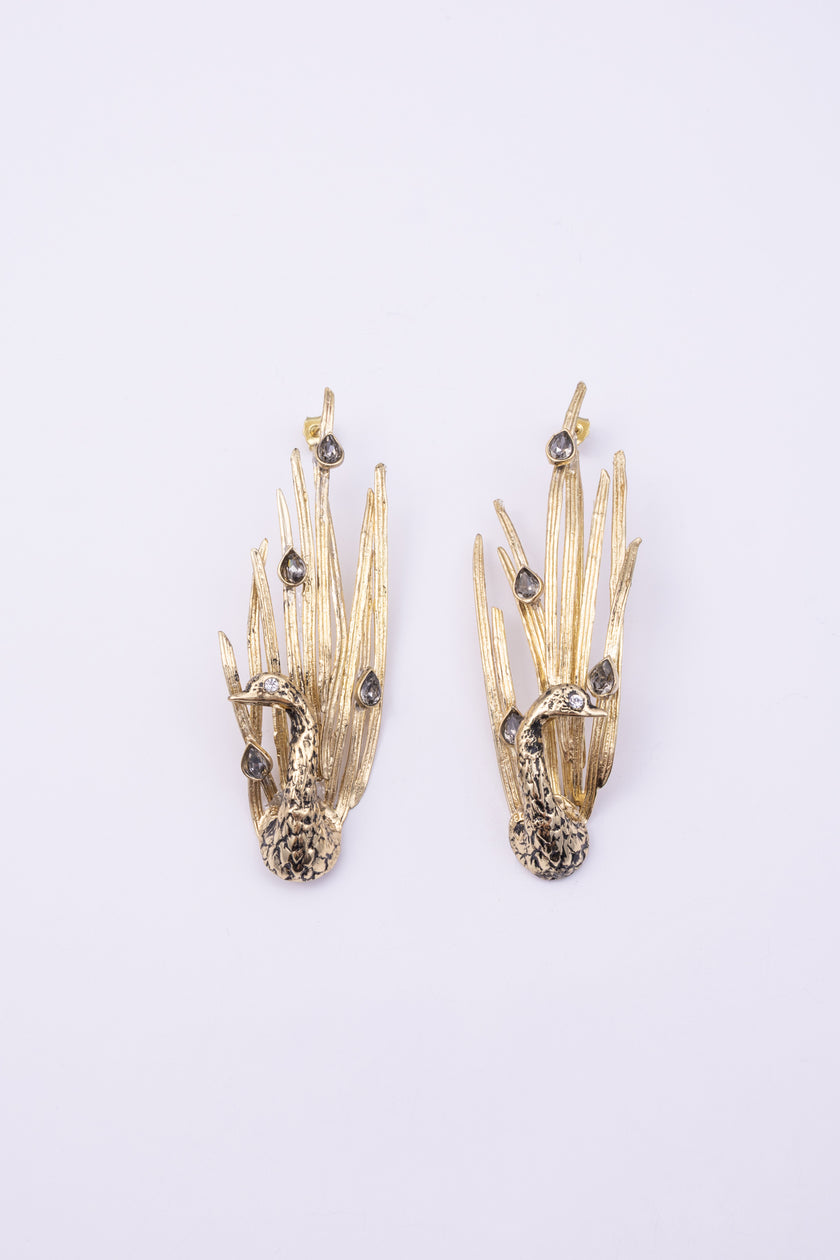 Peacock Earrings side view, handmade brass sculptural earrings with hammered bird body and layered feather plumage

