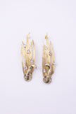 Peacock Earrings close up, handmade brass earrings with faceted teardrop crystals set into patinated feather blades
