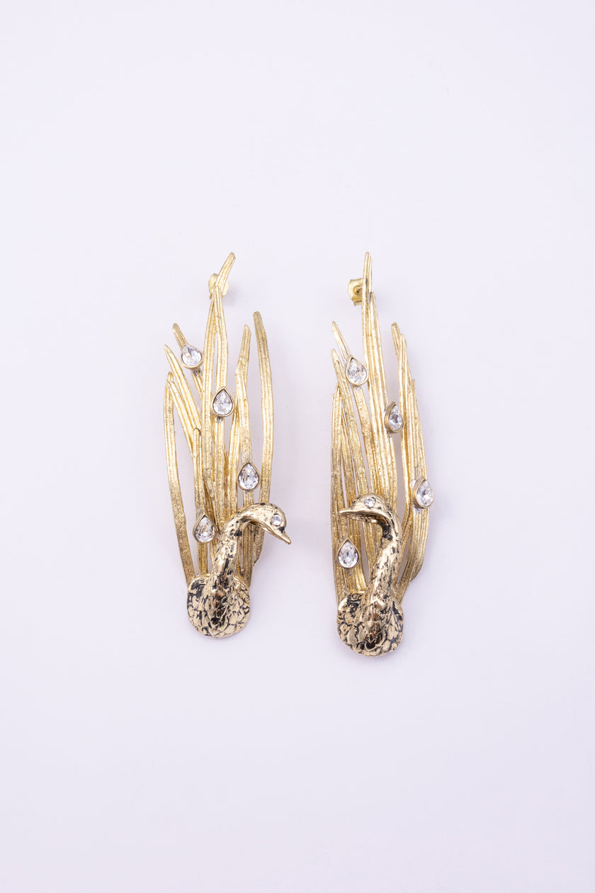 Peacock Earrings close up, handmade brass earrings with faceted teardrop crystals set into patinated feather blades
