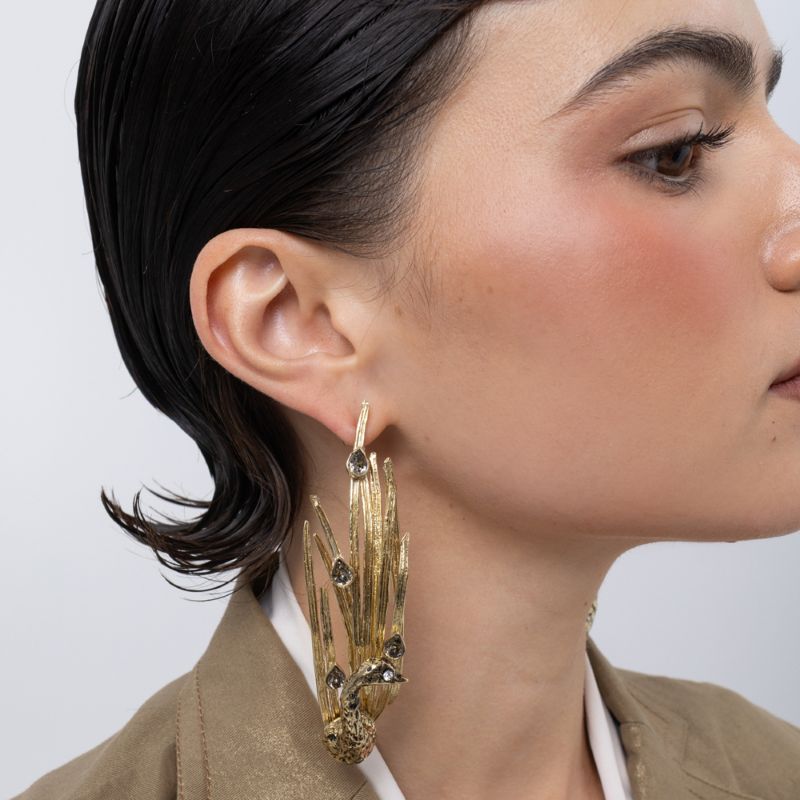Peacock Earrings on model close up, handmade brass earrings with crystal eye, patinated feather blades and bright varnished finish
