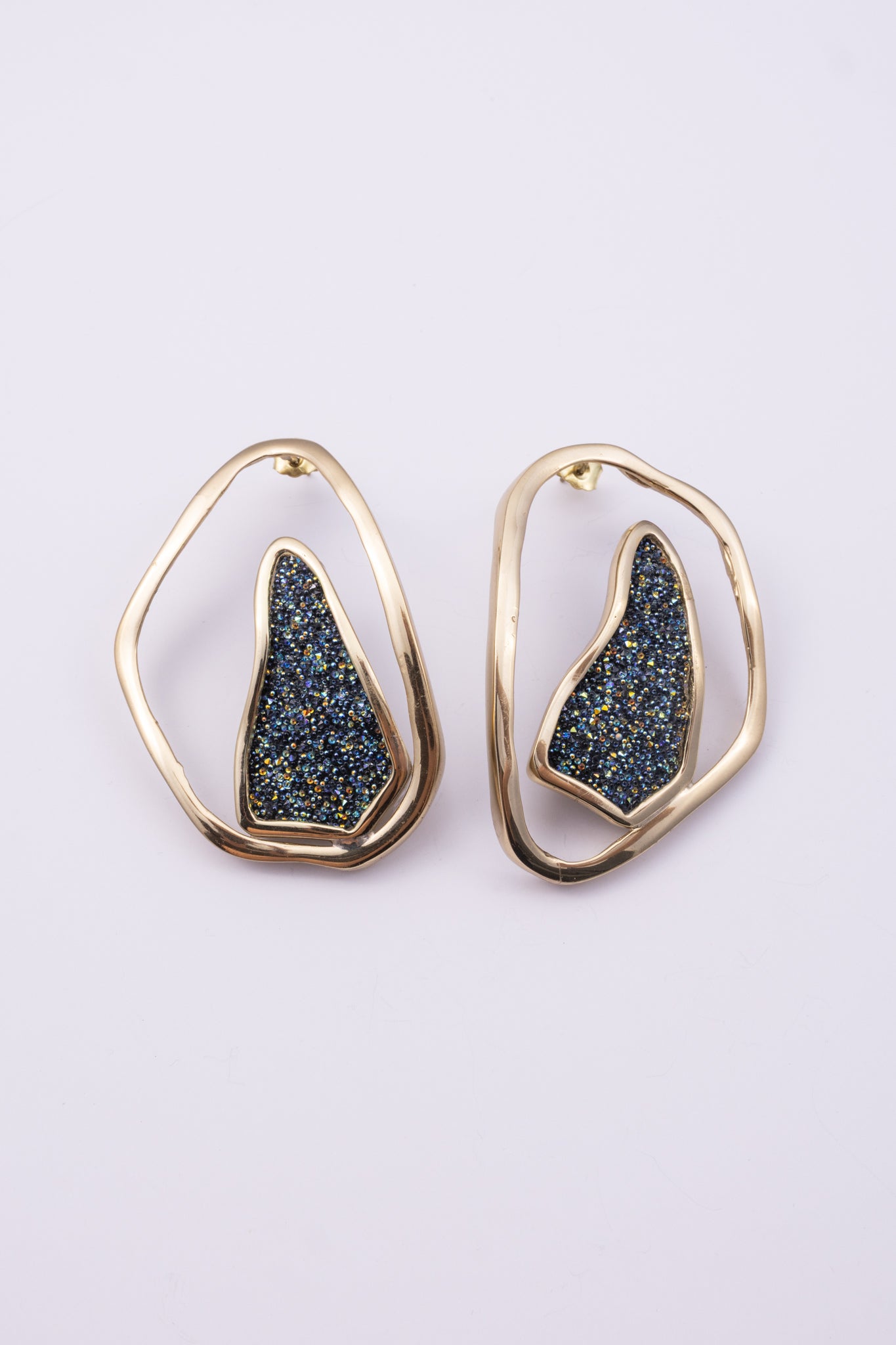 Shimmer Earrings close up: handmade brass earrings with tiny faceted crystals set in a sculpted bezel