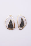 Shimmer Earrings angle view: handmade brass sculptural earrings with overlapping rippled frame