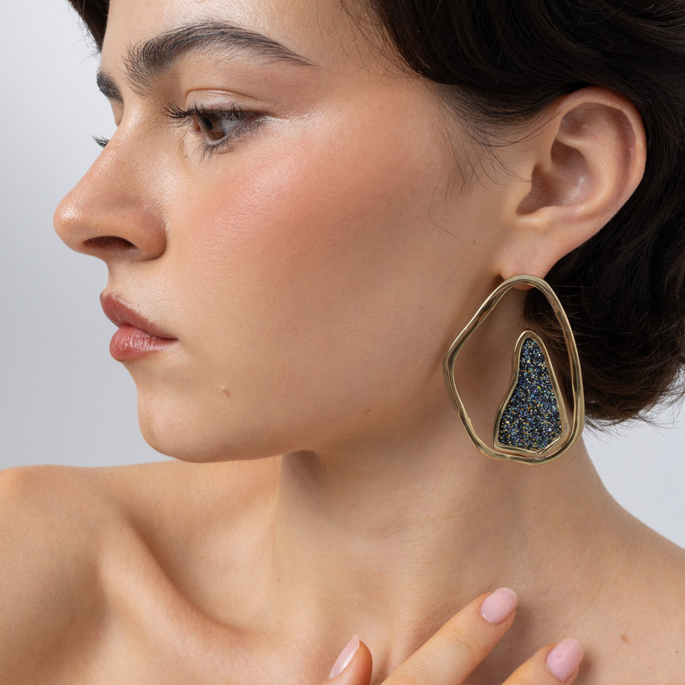 Shimmer Earrings on model: handmade brass statement earrings worn on ear showing scale and proportion
