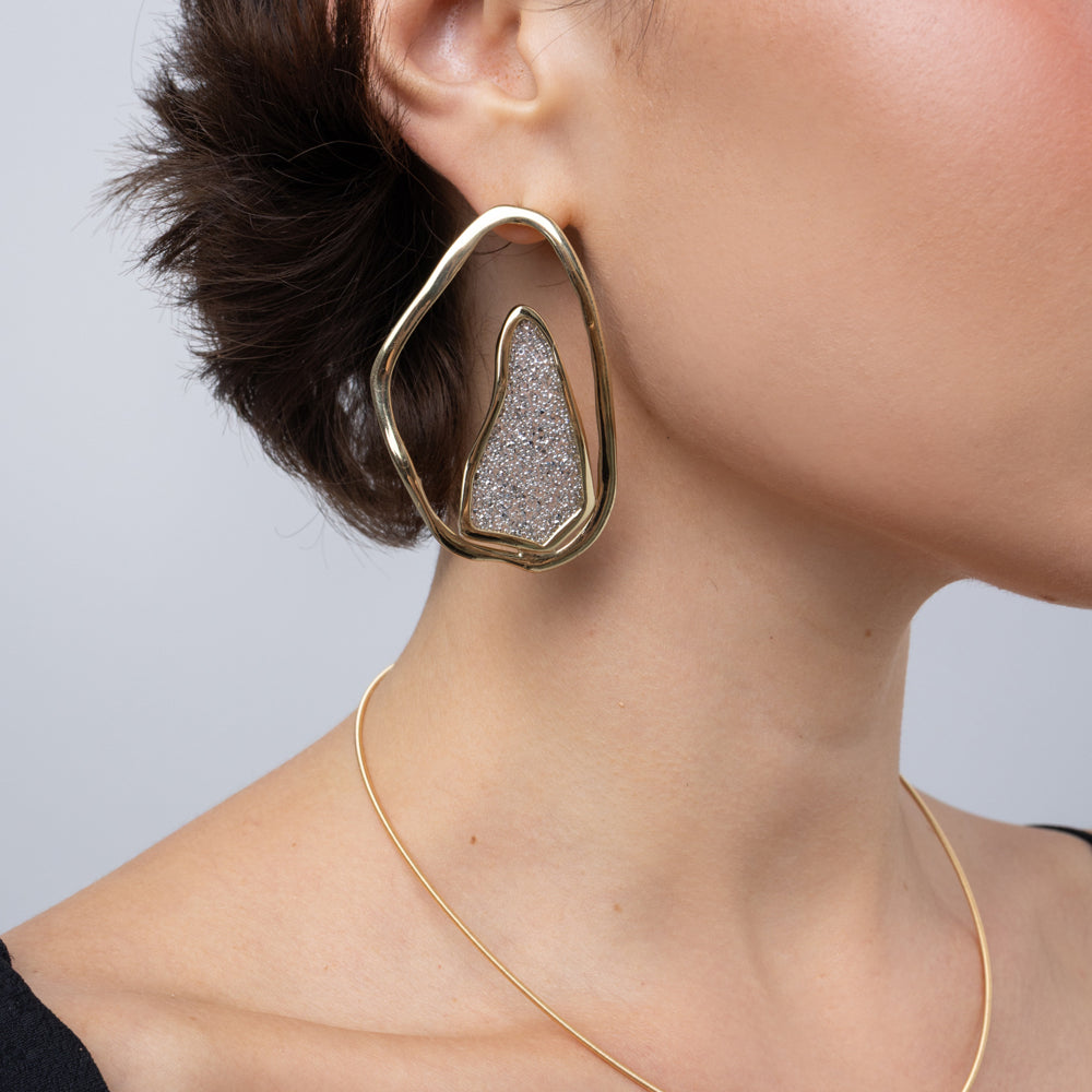 Shimmer Earrings on model, side view: handmade brass boho statement earrings with sparkling crystals