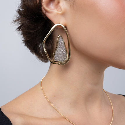 Shimmer Earrings on model, side view: handmade brass boho statement earrings with sparkling crystals