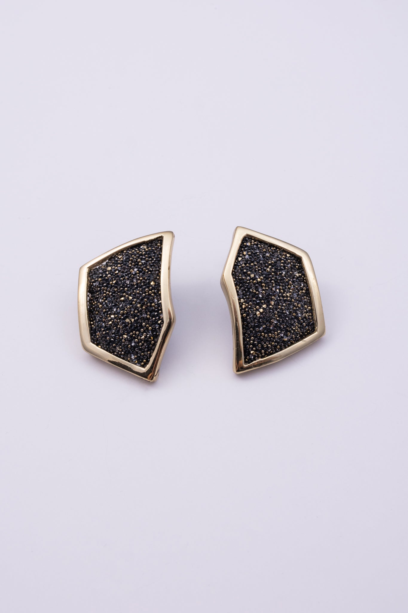 Sparkle Earrings close up: handmade brass earrings with tiny faceted crystals set in a sleek brass frame