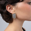 Sparkle Earrings on model: handmade brass boho statement earrings with angular frame and crystal inset