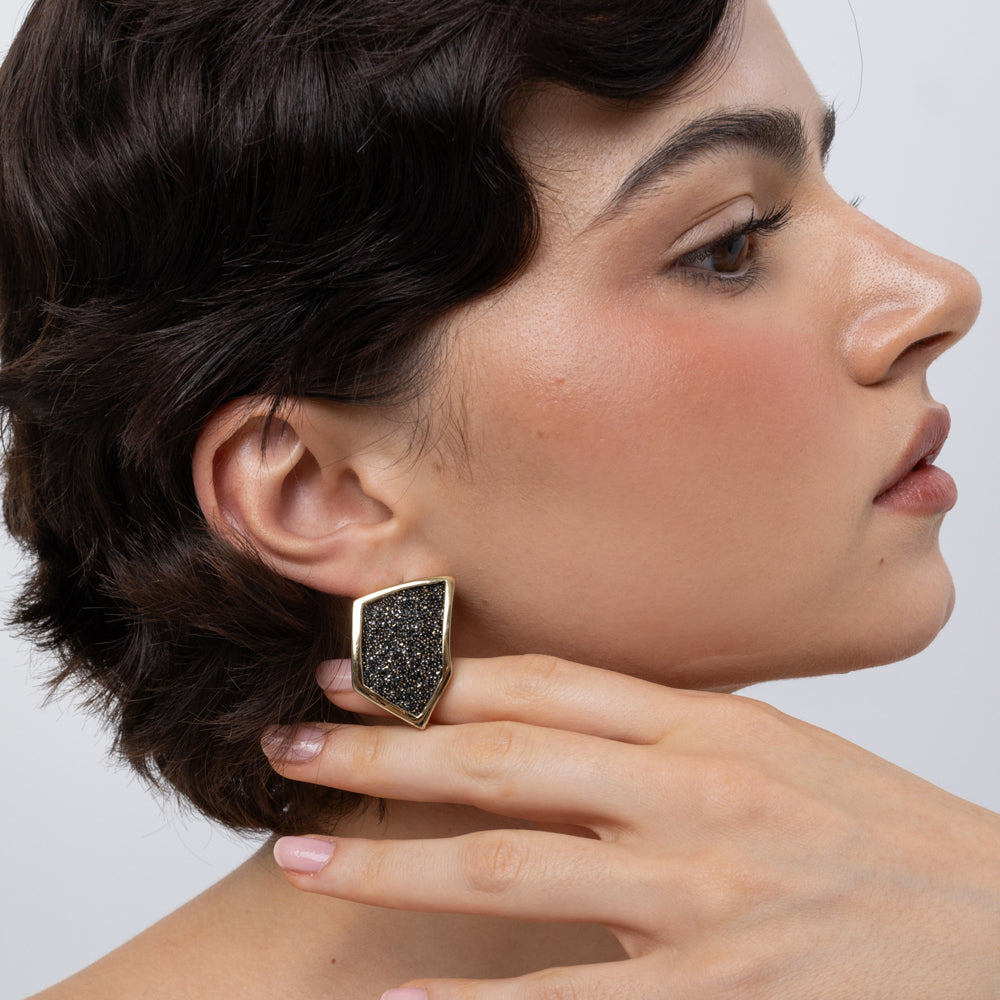 Sparkle Earrings on model, side view: handmade brass geometric earrings with sparkling crystals
