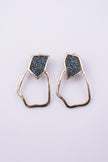 Glow Earrings on white background: handmade brass statement earrings with crystal shard and open organic drop