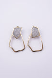 Glow Earrings close up: handmade brass earrings with tiny faceted crystals set in a sleek brass frame