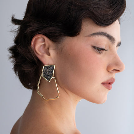Glow Earrings on model: handmade brass statement earrings worn on ear showing scale and proportion