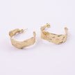 Ripple Hoop Earrings close up, handmade brass earrings with creased molten texture and post fastening
