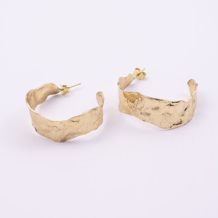 Ripple Hoop Earrings close up, handmade brass earrings with creased molten texture and post fastening
