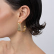 Ripple Hoop Earrings on model, handmade brass wide hoop earrings worn on ear showing scale and rippled texture
