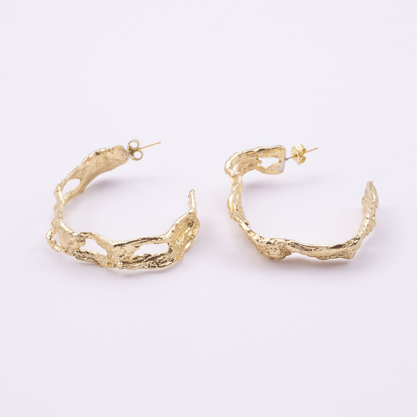Lichen Hoop Earrings angle view, handmade brass sculptural hoop earrings with tangled lace like band and irregular openings