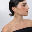Lichen Hoop Earrings on model, handmade brass openwork hoop earrings worn on ear showing scale and lacy texture