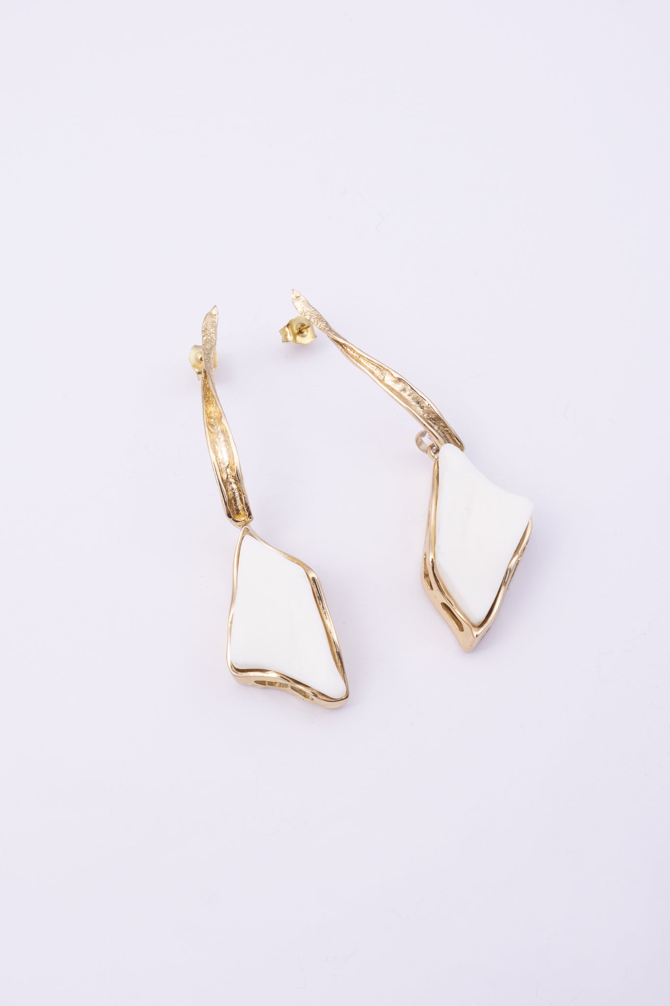 Kite Earrings, handmade brass long drop earrings with twisted textured stem and raw resin stone on white background
