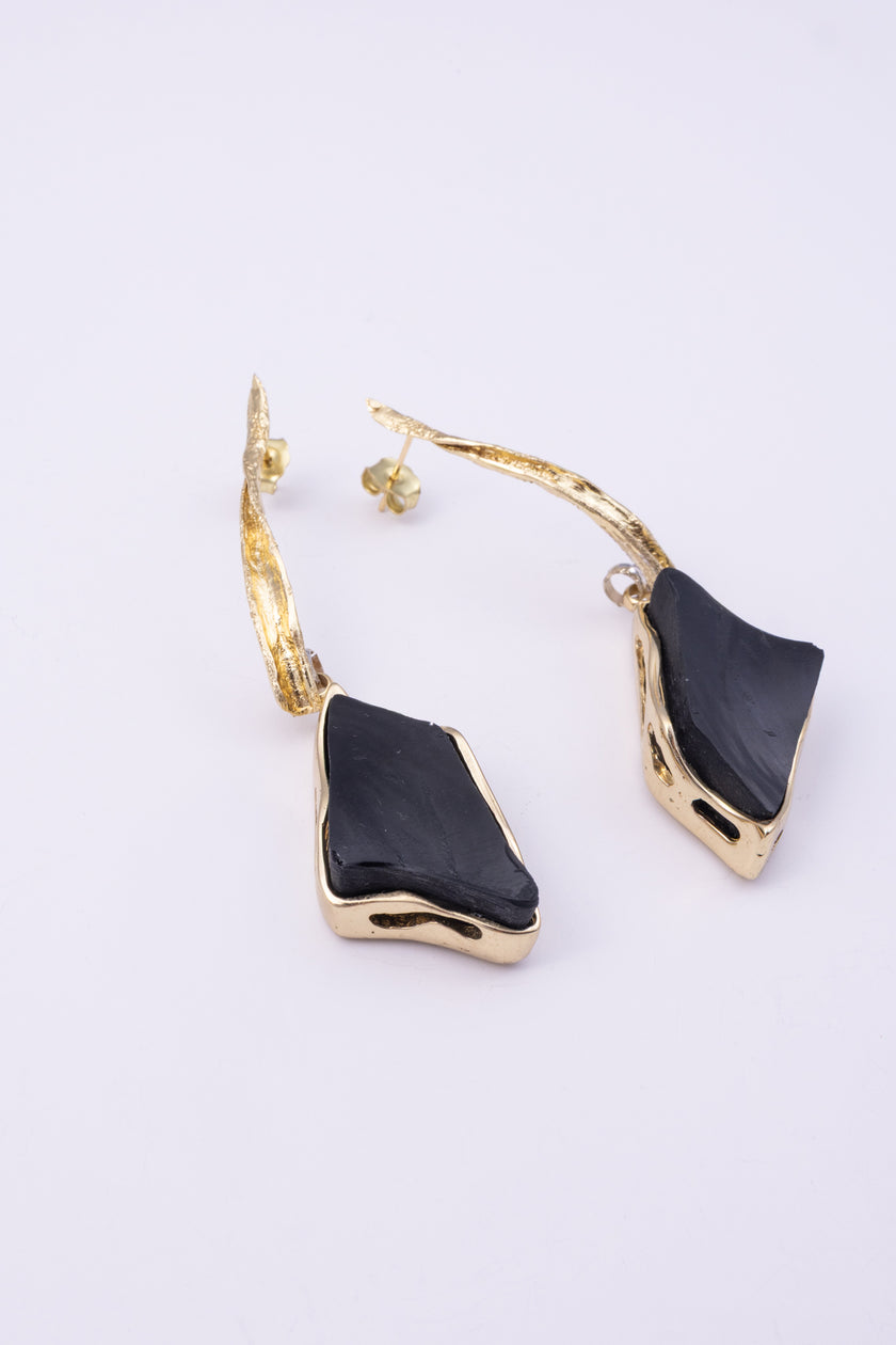 Kite Earrings close up, handmade brass earrings with glassy resin stone and hand finished brass detail
