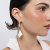 Kite Earrings on model, handmade brass long drop earrings worn on ear showing length and resin stone movement