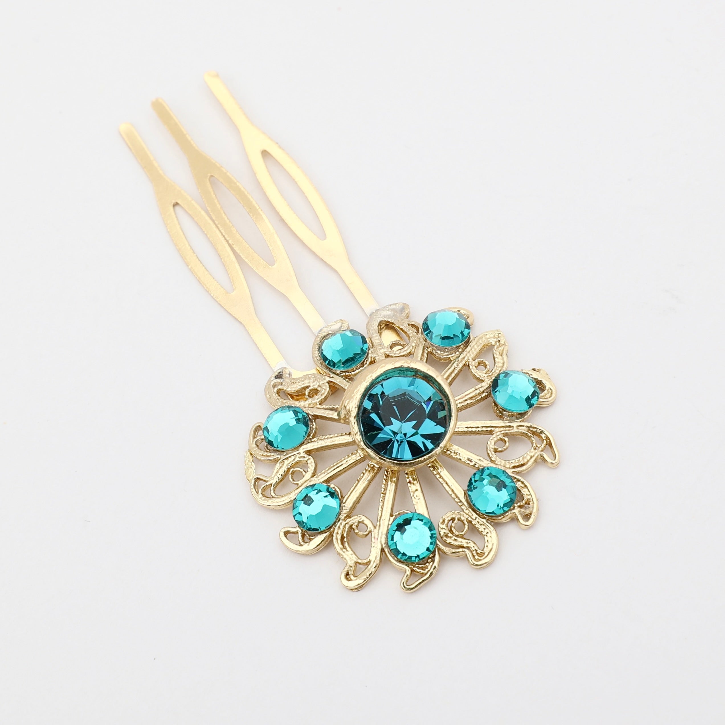 Gold hairpin with turquoise gemstones on a white background