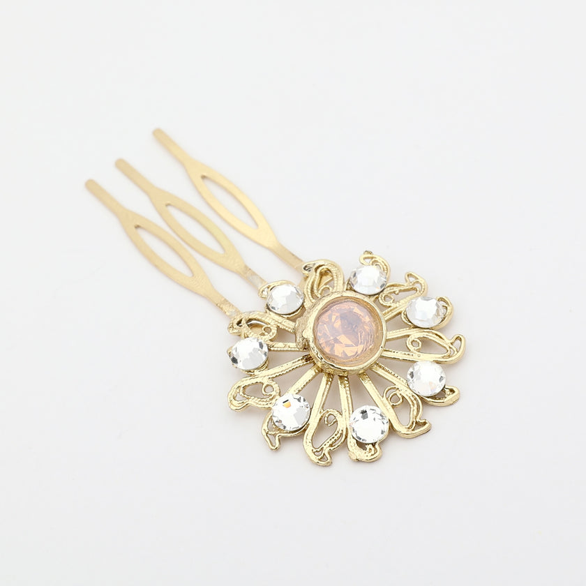 Gold hair comb with decorative top on a white background