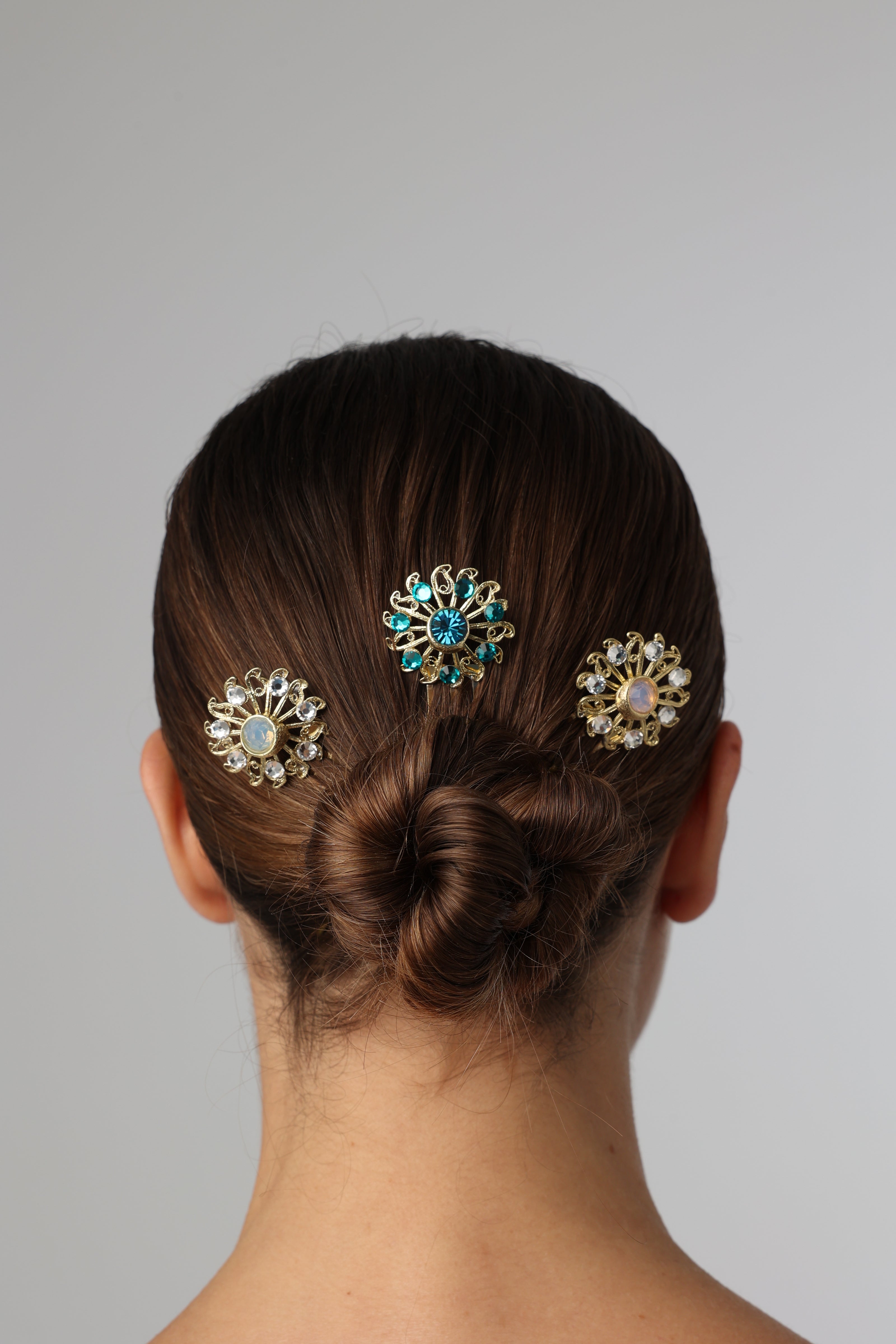 Individual handmade bronze hair comb featuring blue and white crystals on a white background.