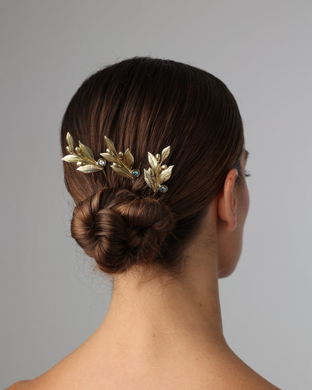 Handcrafted gold-plated hair pin with sculpted olive leaf design and subtle crystal accents, inspired by Greek symbolism.