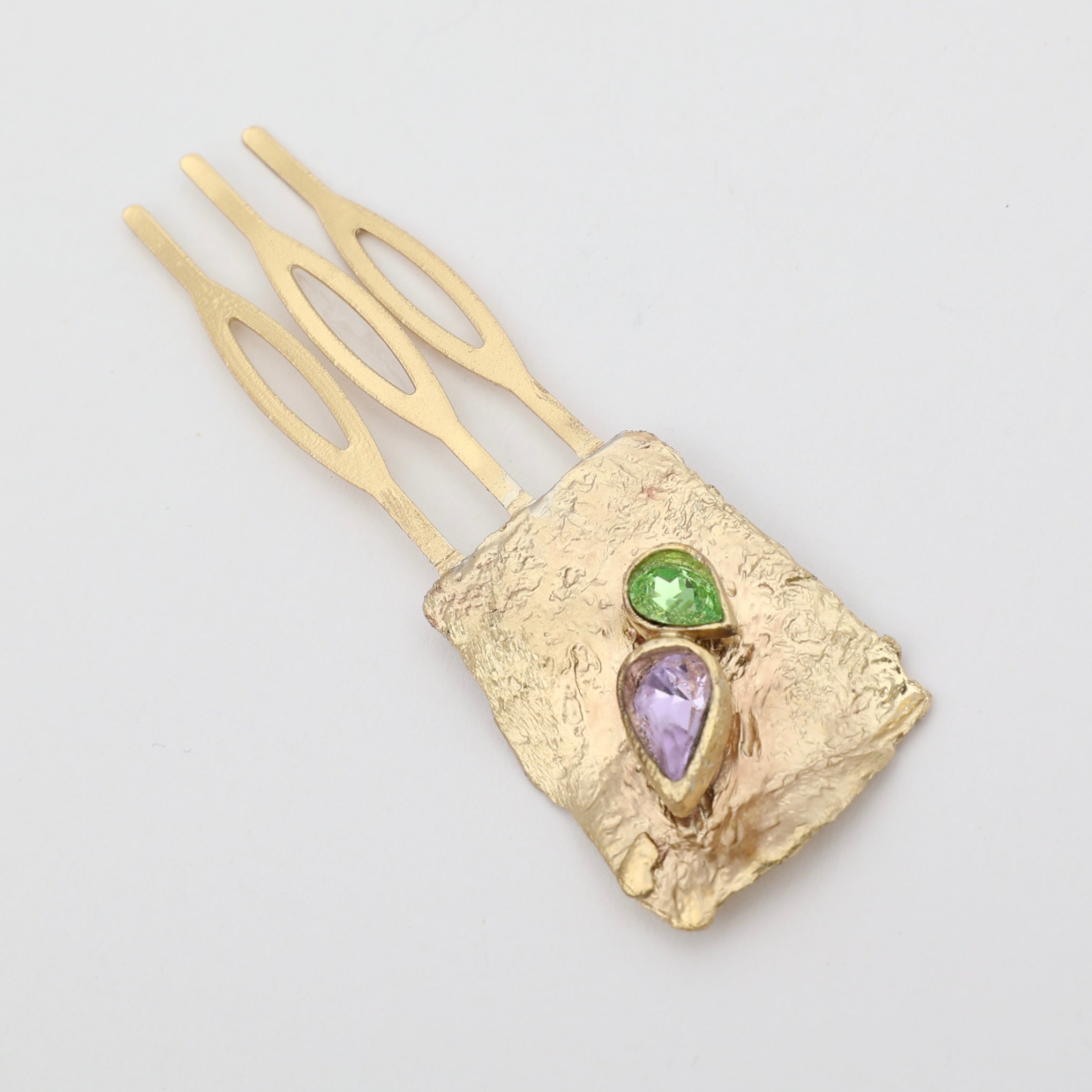 Handcrafted gold-plated hair accessory with natural gemstones, featuring an organic sculptural design.