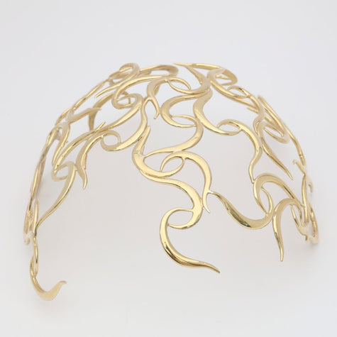 handmade brass sculptural wave coif headpiece, flat lay front view, artisan statement jewelry made in Greece