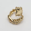 Gold octopus-shaped ring on a light gray background