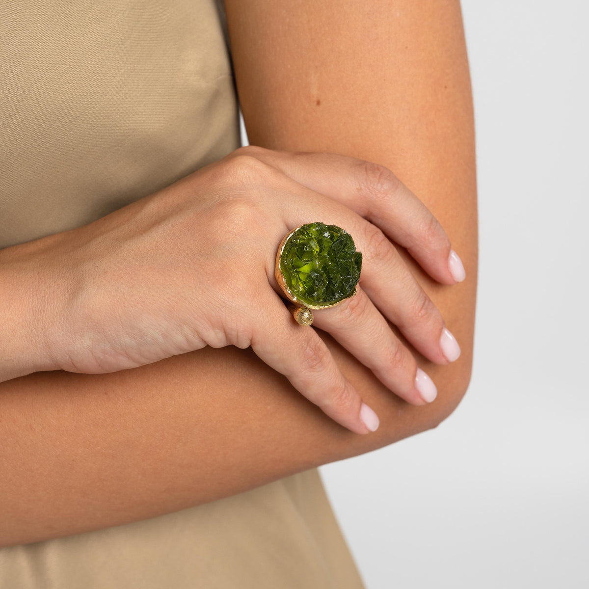 Artisan gold-tone brass statement ring with bold deep green crackled resin round centerpiece and textured bead detail — Rocky Ring by Kalliope Jewelry, crafted in Greece