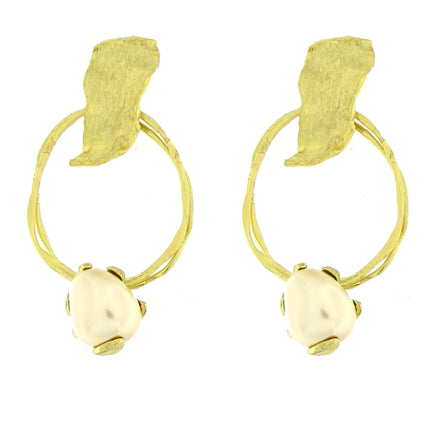 Pair of gold hoop earrings with leaf-like designs on a white background