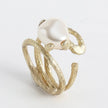 Close-up product shot of handmade textured brass adjustable twig ring with baroque pearl centerpiece — Sec Ring by Kalliope Jewelry, crafted in Greece