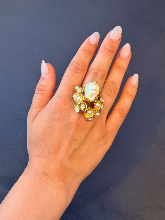 Aurea Ring close-up — handmade brass sculptural ring with baroque pearl, small pearls and crystal embellishments
