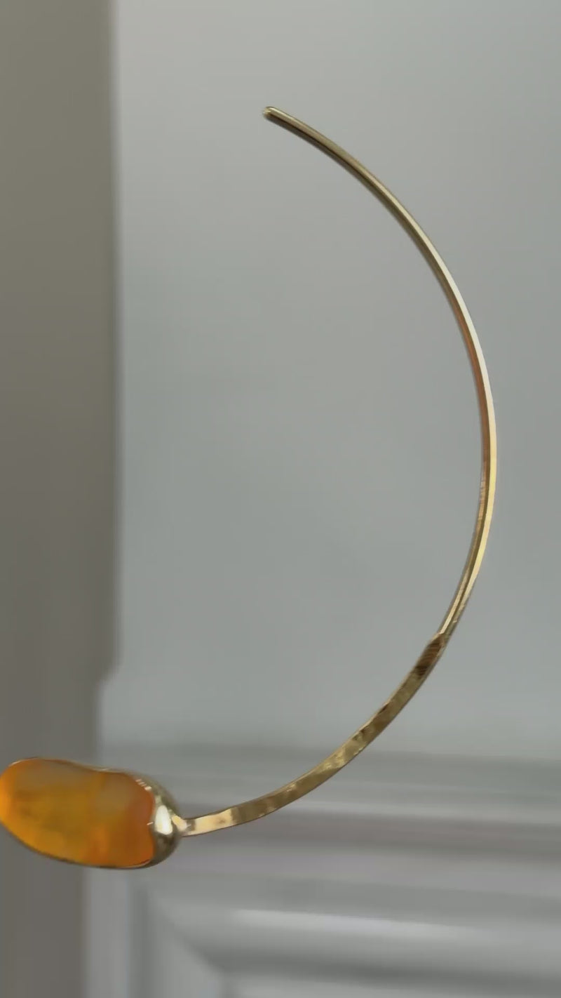 Earthpulse Necklace detail — handmade brass hammered wire collar with polished resin accent